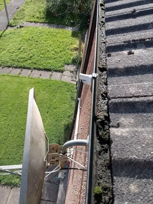 View along a roofline gutter during a gutter clean