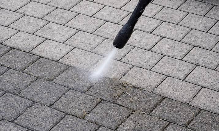 Pressure washer lance cleaning paving